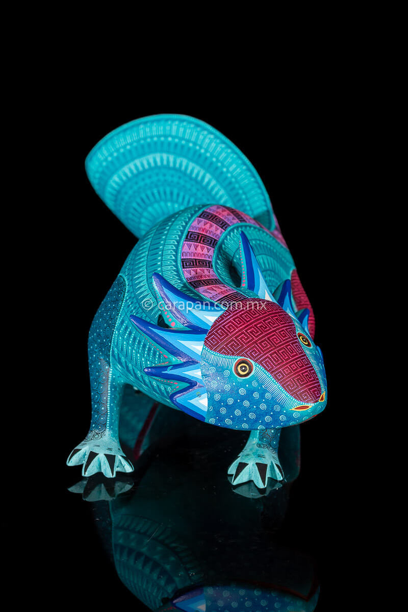 Axolotl Oaxacan wood carving decorated with zapotec symbols in a turquoise & Fucsia palette