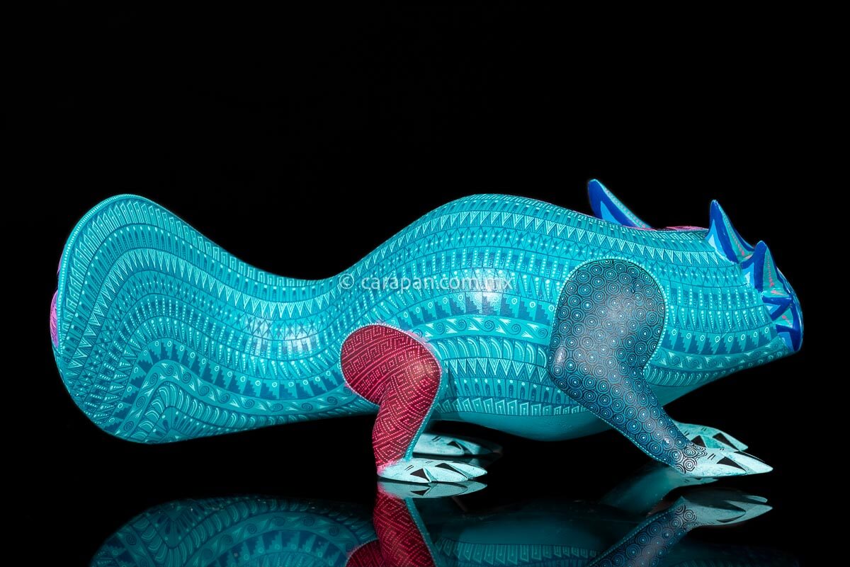 Axolotl Oaxacan wood carving decorated with zapotec symbols in a turquoise & Fucsia palette