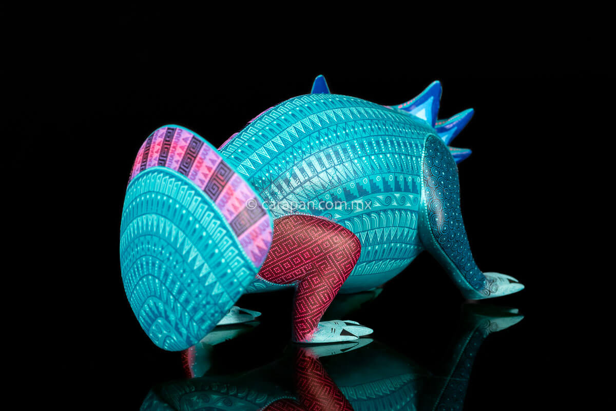 Axolotl Oaxacan wood carving decorated with zapotec symbols in a turquoise & Fucsia palette
