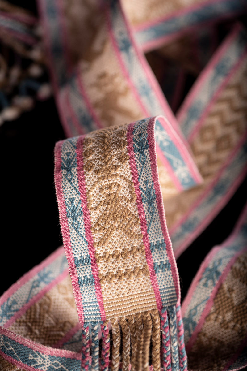 Backstrap Loomed Belt  decorated With Traditional Zapotec Figures in Brown at the center and a stripe with hummingbirds in blue with pink contour on each side One end of the belt is decorated with dolls in pink & the other with boys in blue dyed with natural pigments: Walnut, Cochineal & Indigo