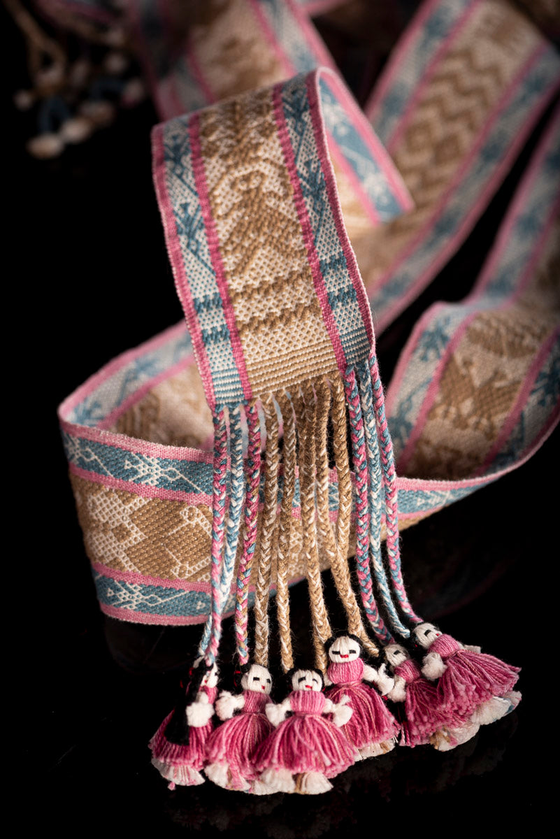 Backstrap Loomed Belt  decorated With Traditional Zapotec Figures in Brown at the center and a stripe with hummingbirds in blue with pink contour on each side One end of the belt is decorated with dolls in pink & the other with boys in blue dyed with natural pigments: Walnut, Cochineal & Indigo