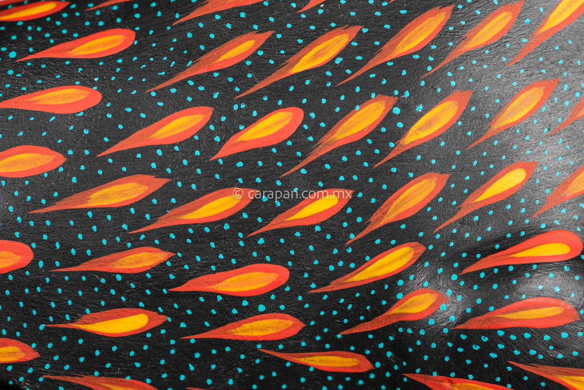 Detail of Black Horse Mexican Wood Carving Alebrije hand painted in red with orange strokes