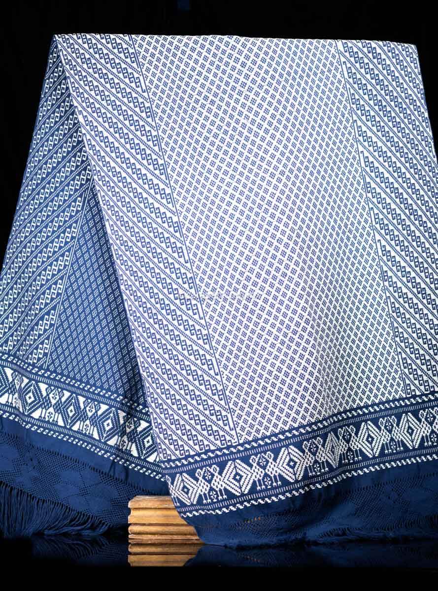 Purepecha Indigenous Textile Backstrap Loomed with mesmerizing patterns in blue and white.Reversible, in one side white dominates over blue. The other side blue dominates over white. The border is decorated with  birds and the blue fringe displays a  hand knotted openwork with flowers.