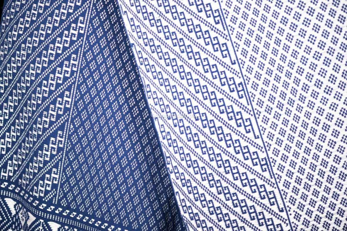 Purepecha Indigenous Textile Backstrap Loomed with mesmerizing patterns in blue and white.Reversible, in one side white dominates over blue. The other side blue dominates over white. The border is decorated with  birds and the blue fringe displays a  hand knotted openwork with flowers.
