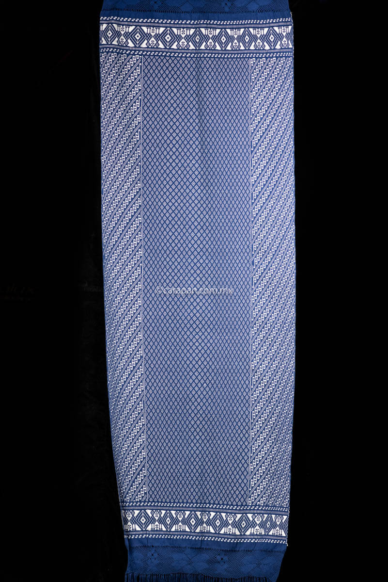 Purepecha Indigenous Textile Backstrap Loomed with mesmerizing patterns in blue and white.Reversible, in one side white dominates over blue. The other side blue dominates over white. The border is decorated with  birds and the blue fringe displays a  hand knotted openwork with flowers.