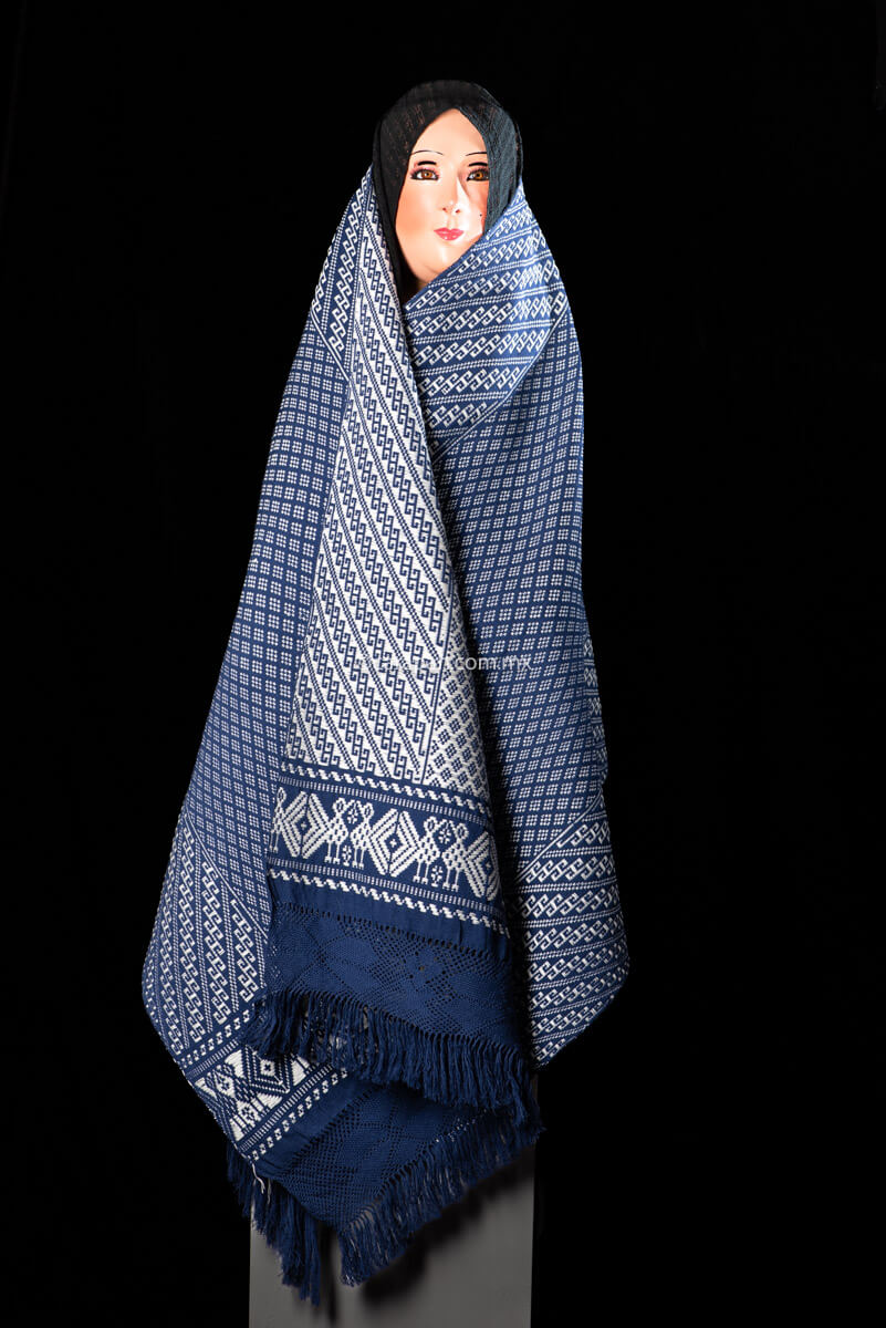 Purepecha Indigenous Textile Backstrap Loomed with mesmerizing patterns in blue and white.Reversible, in one side white dominates over blue. The other side blue dominates over white. The border is decorated with  birds and the blue fringe displays a  hand knotted openwork with flowers.