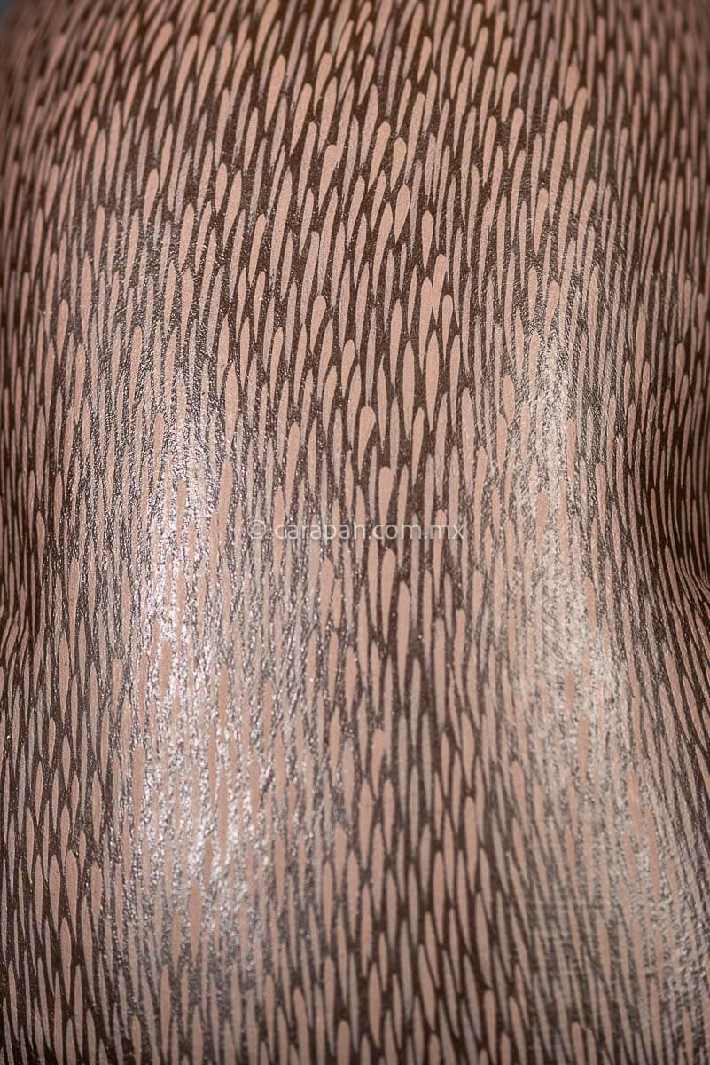 Detail of Mexican Wooden Sculpture of a gray Rabbit Looking Backwards with delicate black strokes that resemble hair & pink oranges It was carved from a single block of wood