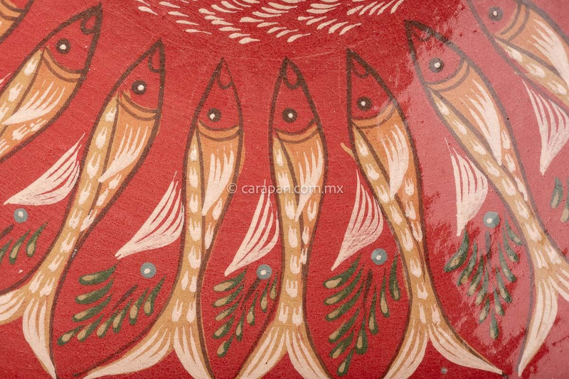 Glazed Bowl with wave pattern contour. An ensemble of many fish surround the center creating a captivating design. The center is decorated with a beige star and a fish around it
