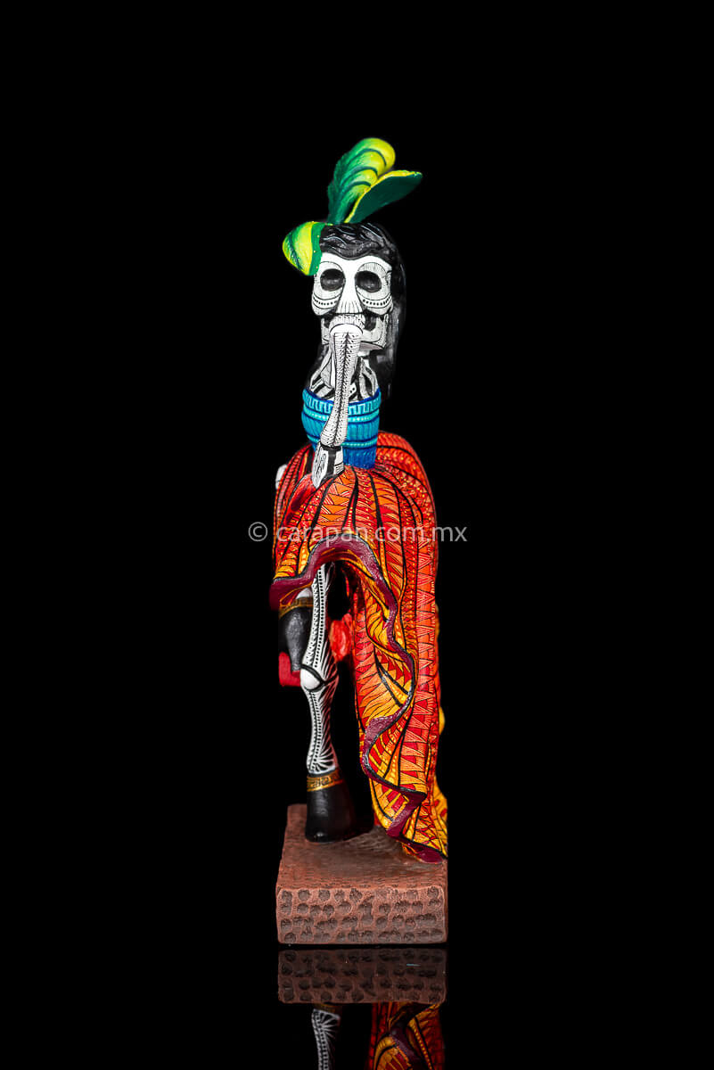 Day of the Dead Wooden Sculpture Mexican Catrina dancing can can lifting up her skirt she wears 3 feather haad dress, an orange skirt & a blue top her clothes are decoraated with zapotec symbols & the skeleton is meticulously decorated with patterns in black & White