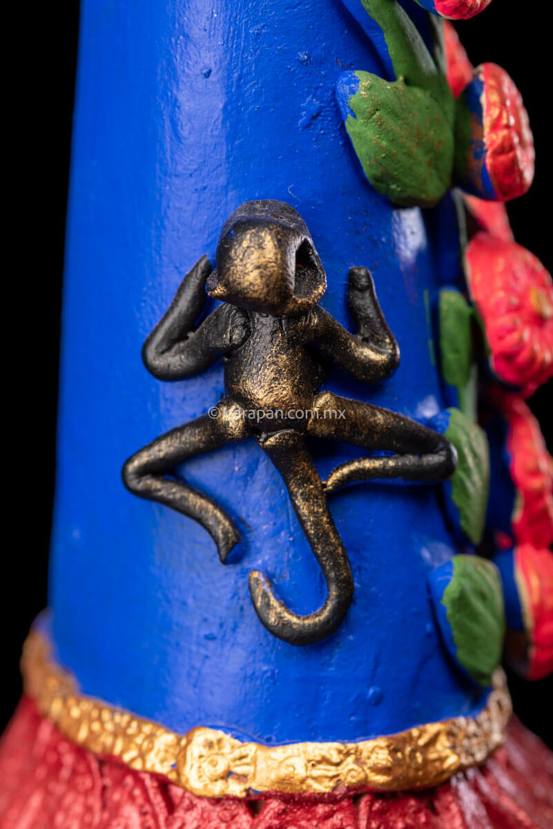 Mexican Clay Catrina Sculpture with blue dress and pink flowers. The catrina is inspired by Two of the most emblematic Frida Kahlo's self portraits with monkeys and parrots. Taht's why this catrina has three parrots and monkeys next to her. Her head dress is decorated with pink flowers and her skull is hand painted.