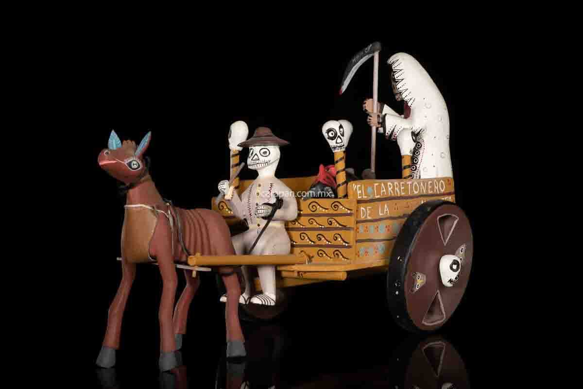 Cart pulled by a brown mule with 1 skeleton as rider & a figure representing the dead on it beside a death devil. The cart displays the legend in spanish that states "saving the world from evil" on one side & "Death's cart driver on the other side"