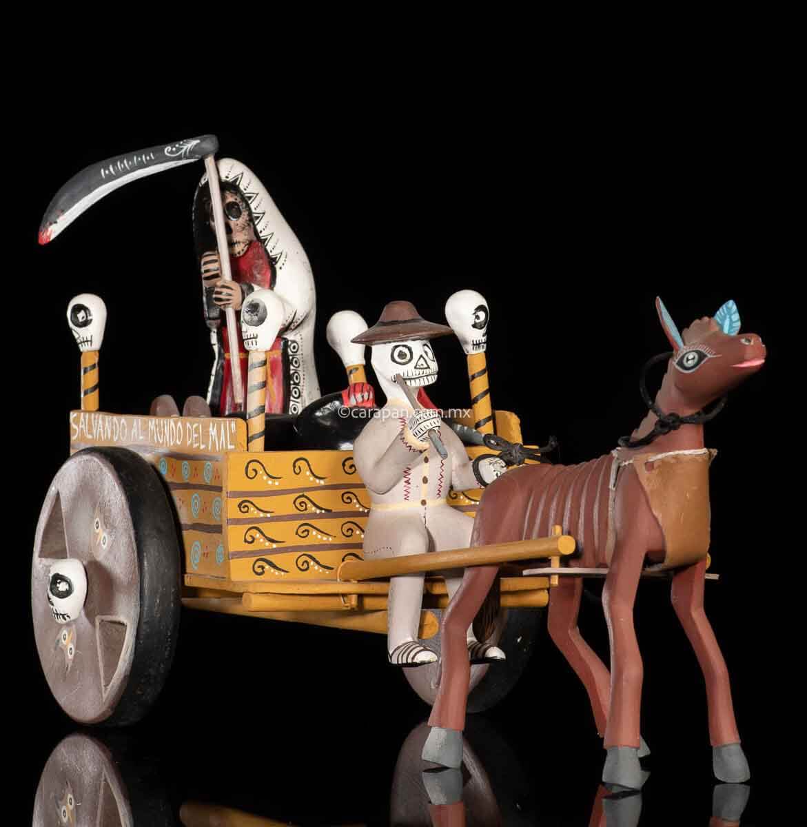 Cart pulled by a brown mule with 1 skeleton as rider & a figure representing the dead on it beside a death devil. The cart displays the legend in spanish that states "saving the world from evil" on one side & "Death's cart driver on the other side"
