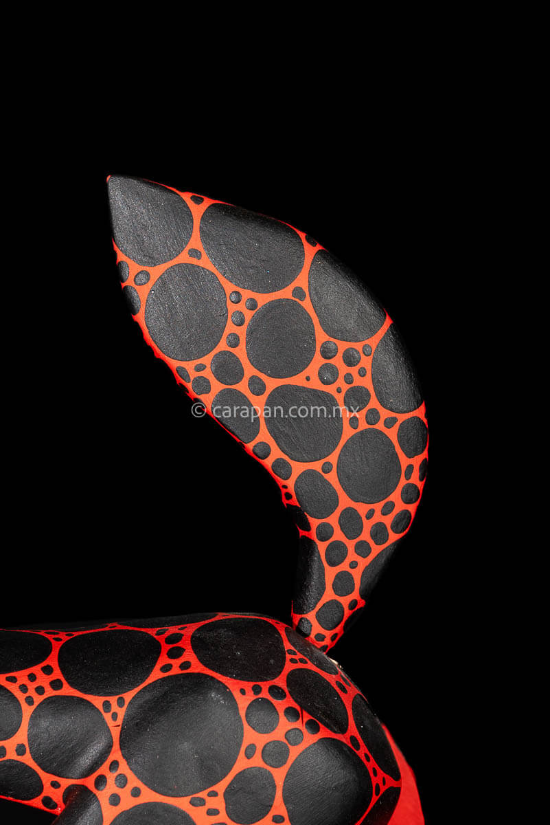 Alebrije Wood Carving Sculpture of walking dog in red with black round patches