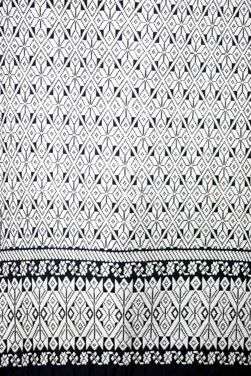 Purepecha Indigenous Textile Backstrap Loomed with mesmerizing patterns in blue and white.Reversible, in one side white dominates over black. The other side black dominates over white.  The fringe displays a  hand knotted openwork with hearts.