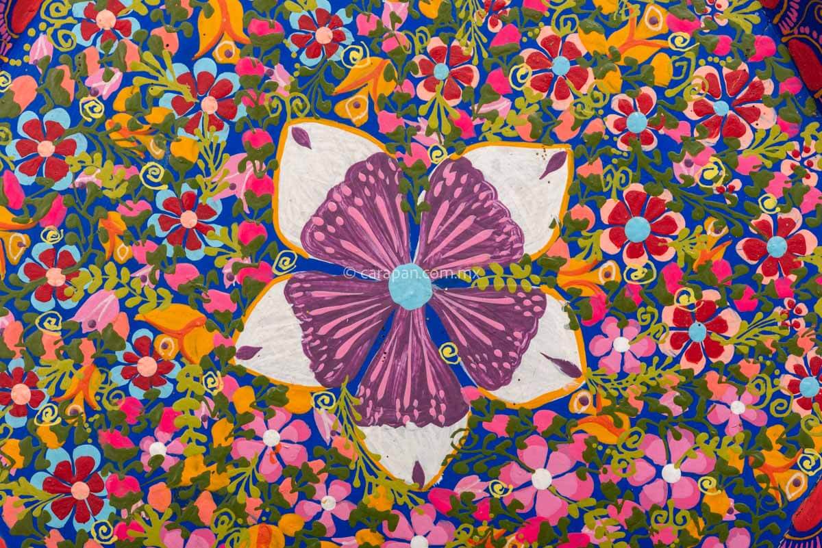 Hexagonal Wooden Tray decorated with red and pink flowers and green leafs over a blue background