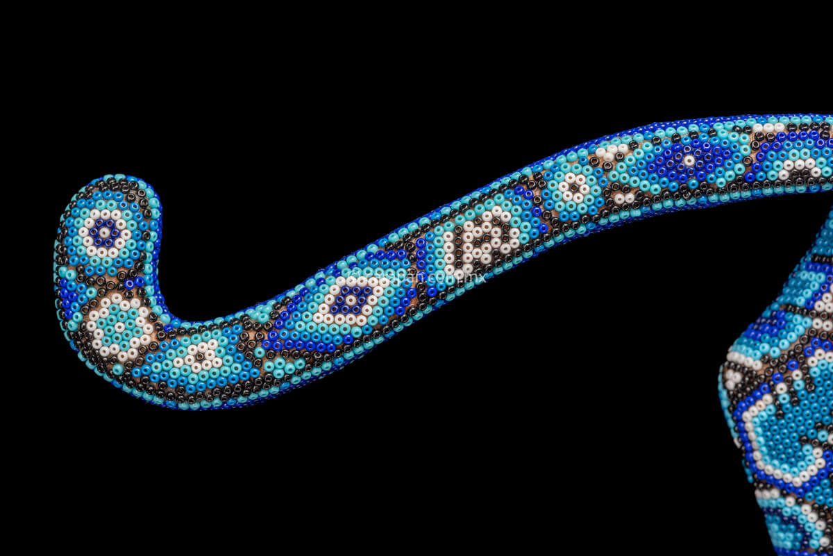 Jaguar Sculpture  Indigenous Art by Huichol People. The jaguar is decorated with beads in blue & white. The beads create a decor of huichol sacred symbols such as a candle, the peyote, the corn & the scorpion, among others. 