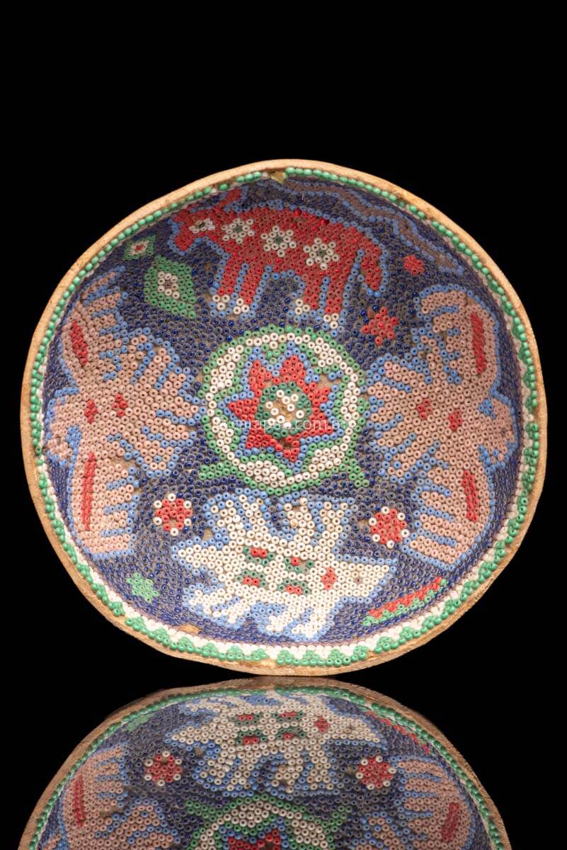 Huichol Gourd covered with beads with peyote symbol at teh center and four sacred animals around it. Such as Eagles & a bull.  Some beads are missing, this is a vintage item.