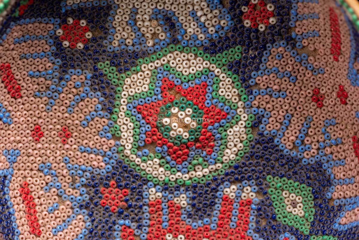 Huichol Gourd covered with beads with peyote symbol at teh center and four sacred animals around it. Such as Eagles & a bull.  Some beads are missing, this is a vintage item. 