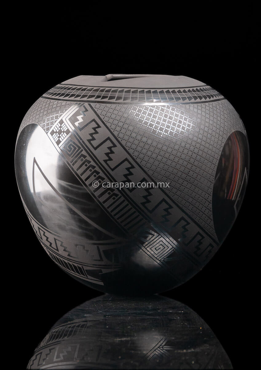 Round shaped Mata Ortiz Pot decorated with black Matte Geometric patterns over black matte burnished clay.