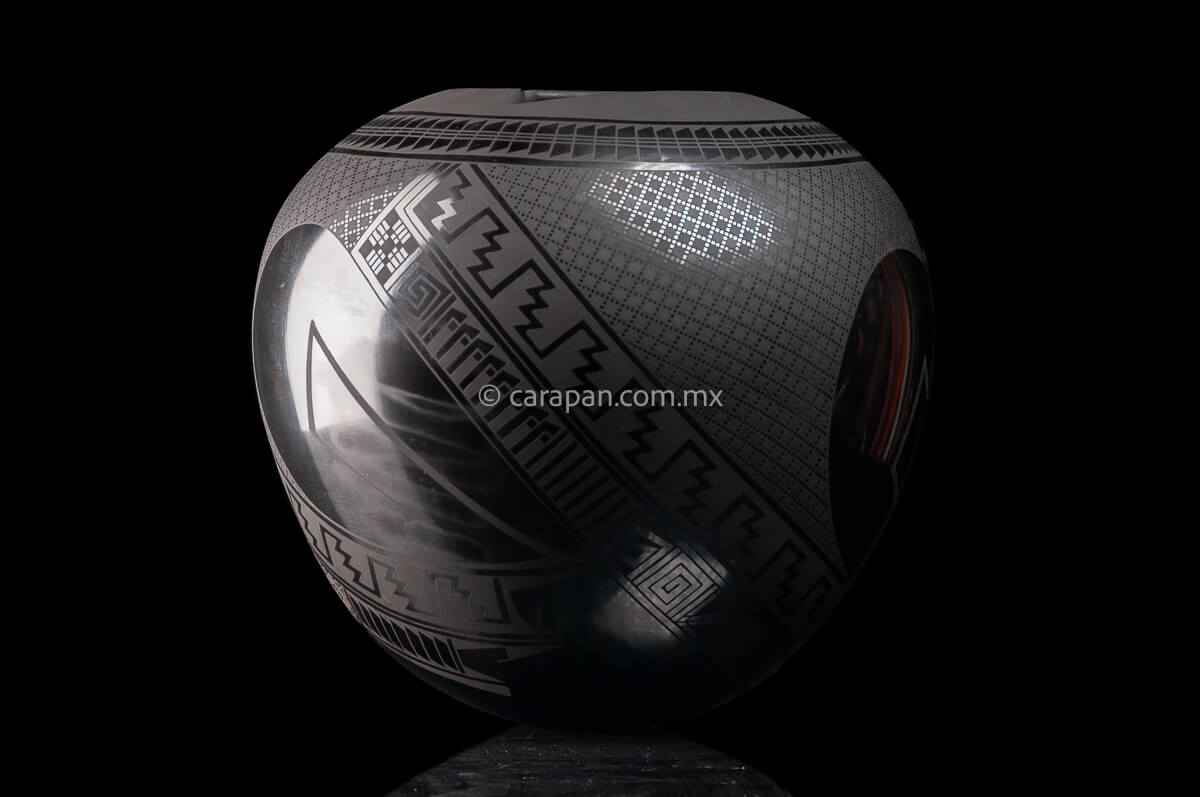 Round shaped Mata Ortiz Pot decorated with black Matte Geometric patterns over black matte burnished clay.