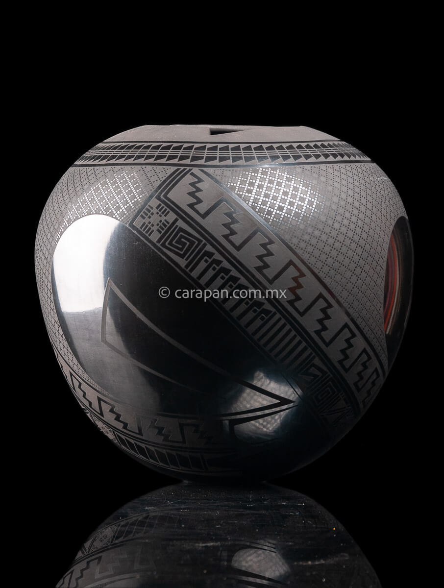 Round shaped Mata Ortiz Pot decorated with black Matte Geometric patterns over black matte burnished clay.