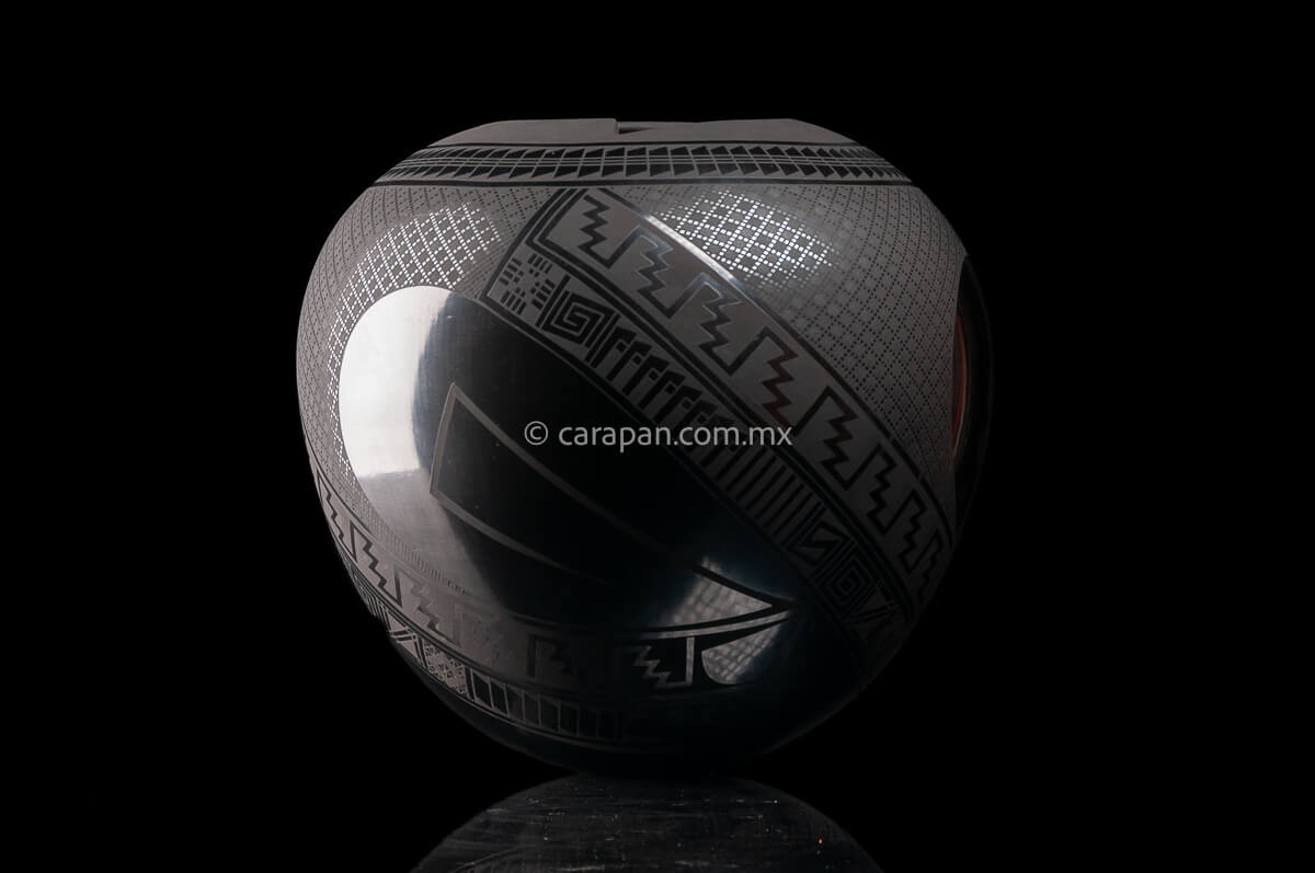 Round shaped Mata Ortiz Pot decorated with black Matte Geometric patterns over black matte burnished clay.