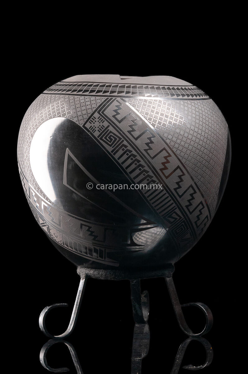Round shaped Mata Ortiz Pot decorated with black Matte Geometric patterns over black matte burnished clay.