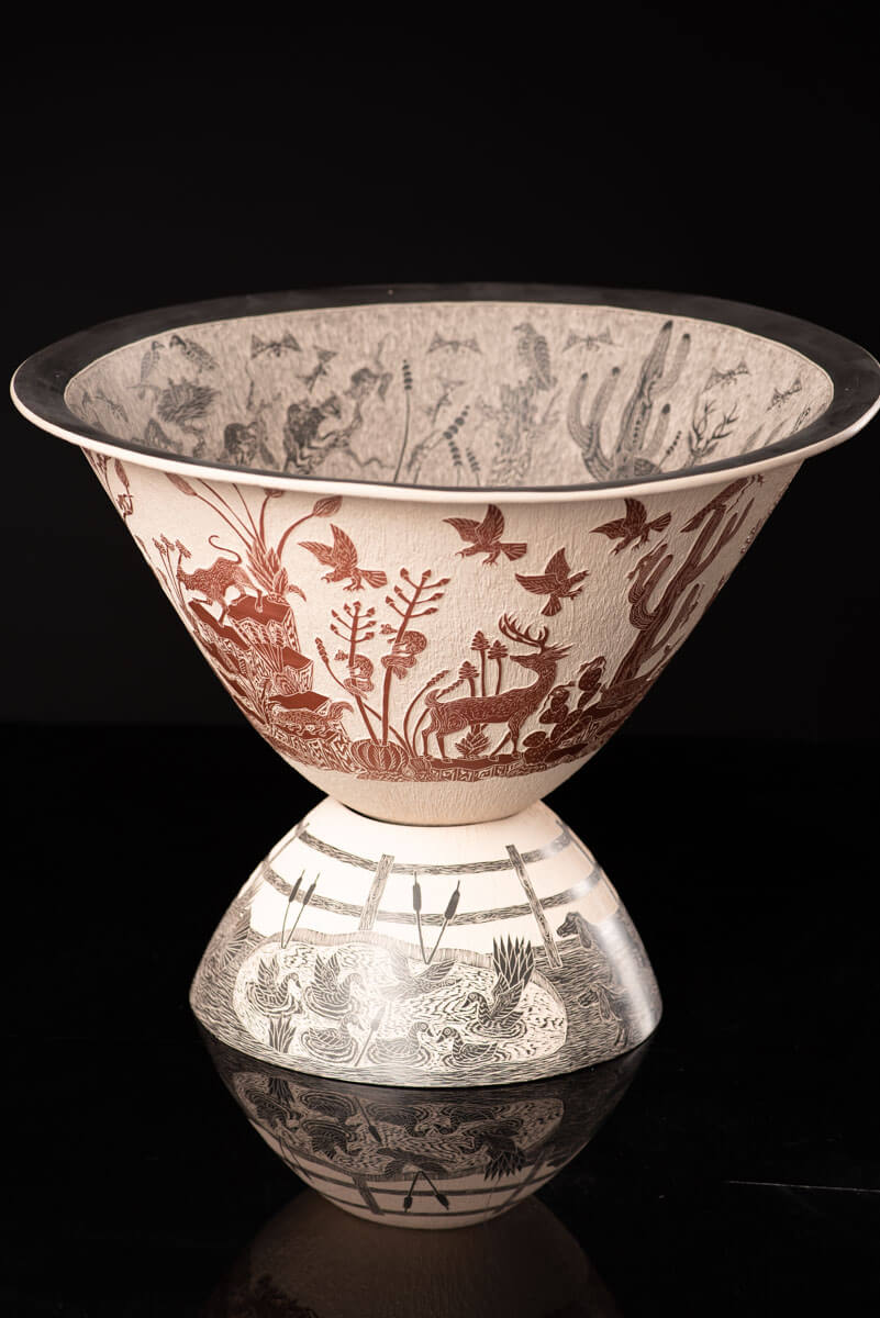 Mata Ortiz pot conic shape decorated with Mexican semi desert & Mountain creatures such as eagles, deer, rams, bats, owls, turkeys, squirrels and bears. The outside of the pot is decorated in brown over beige and the inside in black over beige. The base is also decorated in black over beige with sgraffito technique