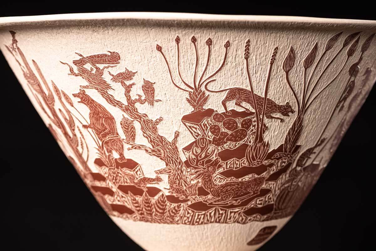 Mata Ortiz pot conic shape decorated with Mexican semi desert & Mountain creatures such as eagles, deer, rams, bats, owls, turkeys, squirrels and bears. The outside of the pot is decorated in brown over beige and the inside in black over beige. The base is also decorated in black over beige with sgraffito technique