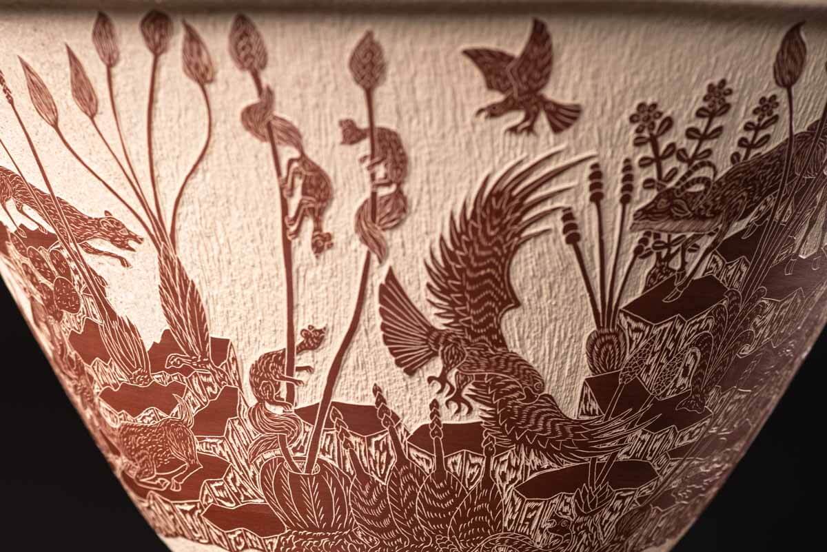 Mata Ortiz pot conic shape decorated with Mexican semi desert & Mountain creatures such as eagles, deer, rams, bats, owls, turkeys, squirrels and bears. The outside of the pot is decorated in brown over beige and the inside in black over beige. The base is also decorated in black over beige with sgraffito technique