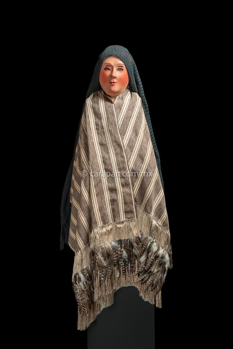 Mexican Indigenous Textile in beige with brown stripes and feathers on manequin.