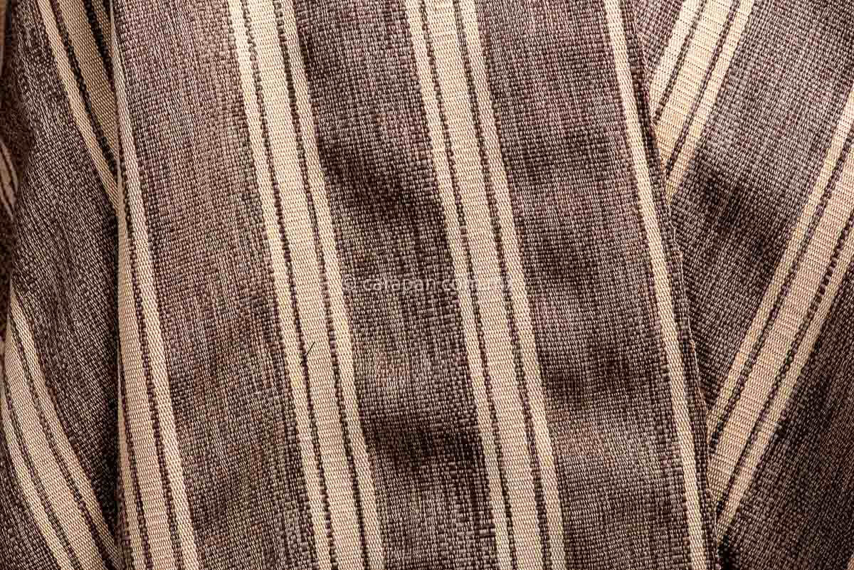 Detail of Mexican Indigenous Textile in beige with brown stripes and feathers.