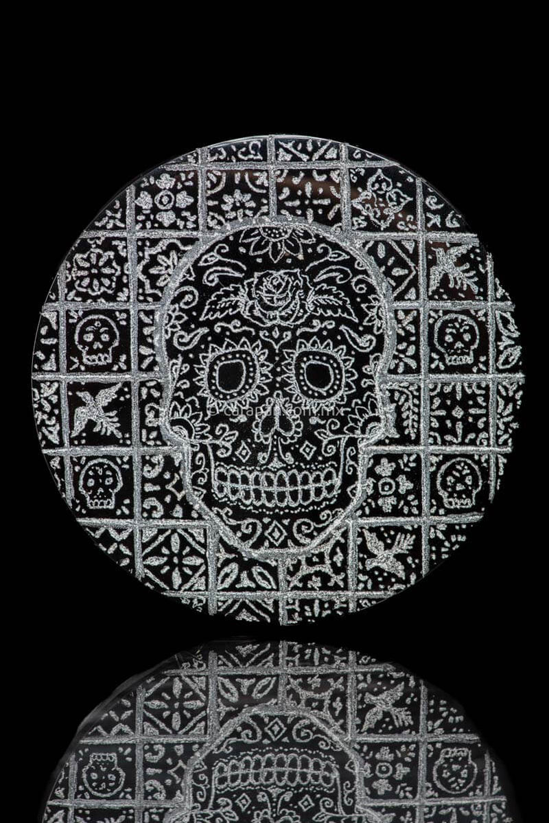 Skull decorated with vegetal motifs over a tile background with birds, flowers and skulls