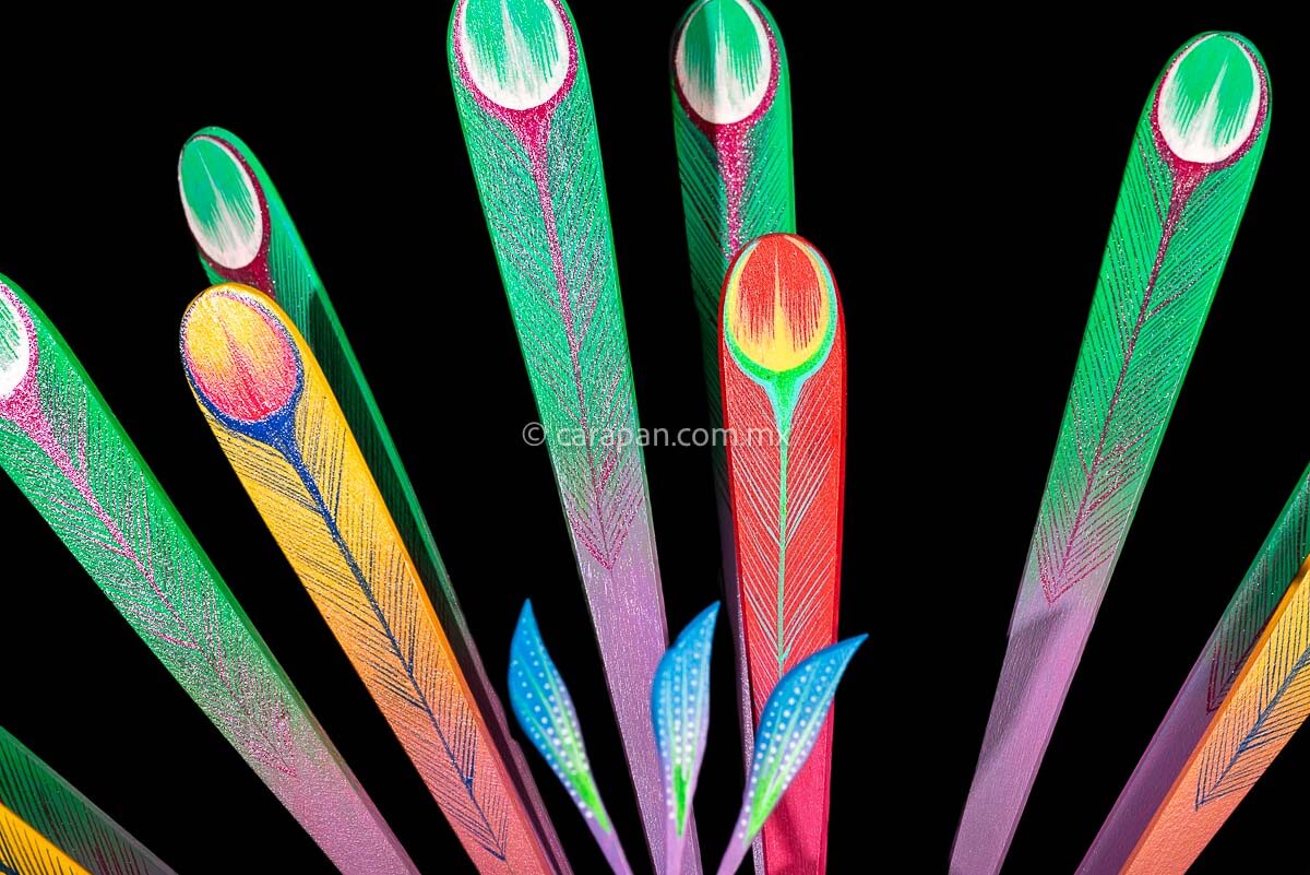 Feather detail of Peacock Wooden Sculpture Handcrafted in Oaxaca Mexico, hand painted displaying multiple colors wings& every feather are detachable