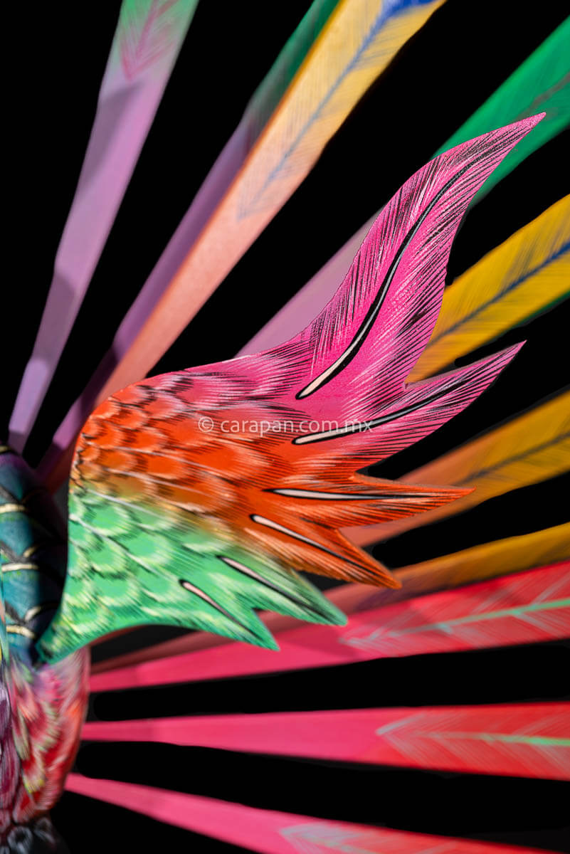 Wing detail of Peacock Wooden Sculpture Handcrafted in Oaxaca Mexico, hand painted displaying multiple colors wings& every feather are detachable