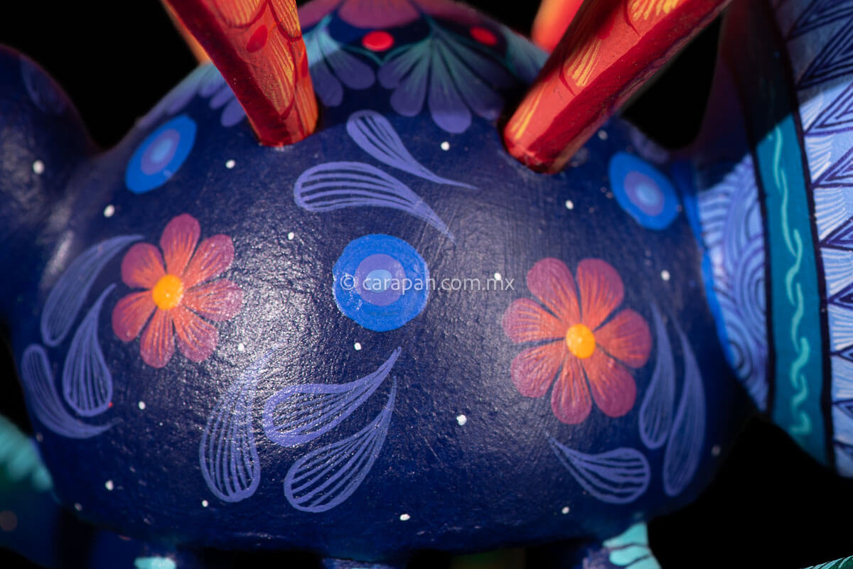 Detail of Wasp Alebrije Wooden Sculpture handcrafted in Oaxaca hand painted blue body & Orange detachable wings