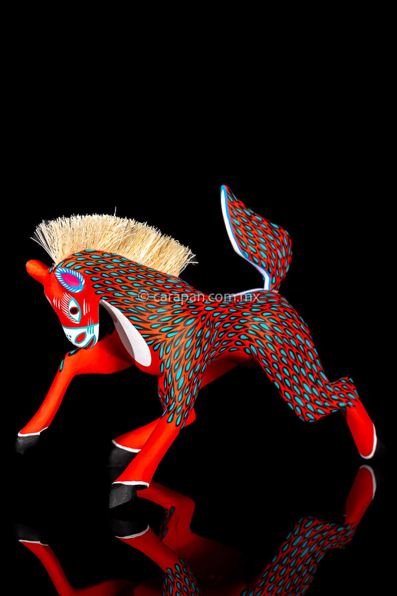 Red Horse Mexican Wood Carving Alebrije hand painted in red with green strokes. Detachable tail