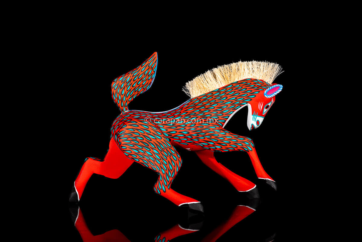Red Horse Mexican Wood Carving Alebrije hand painted in red with green strokes. Detachable tail