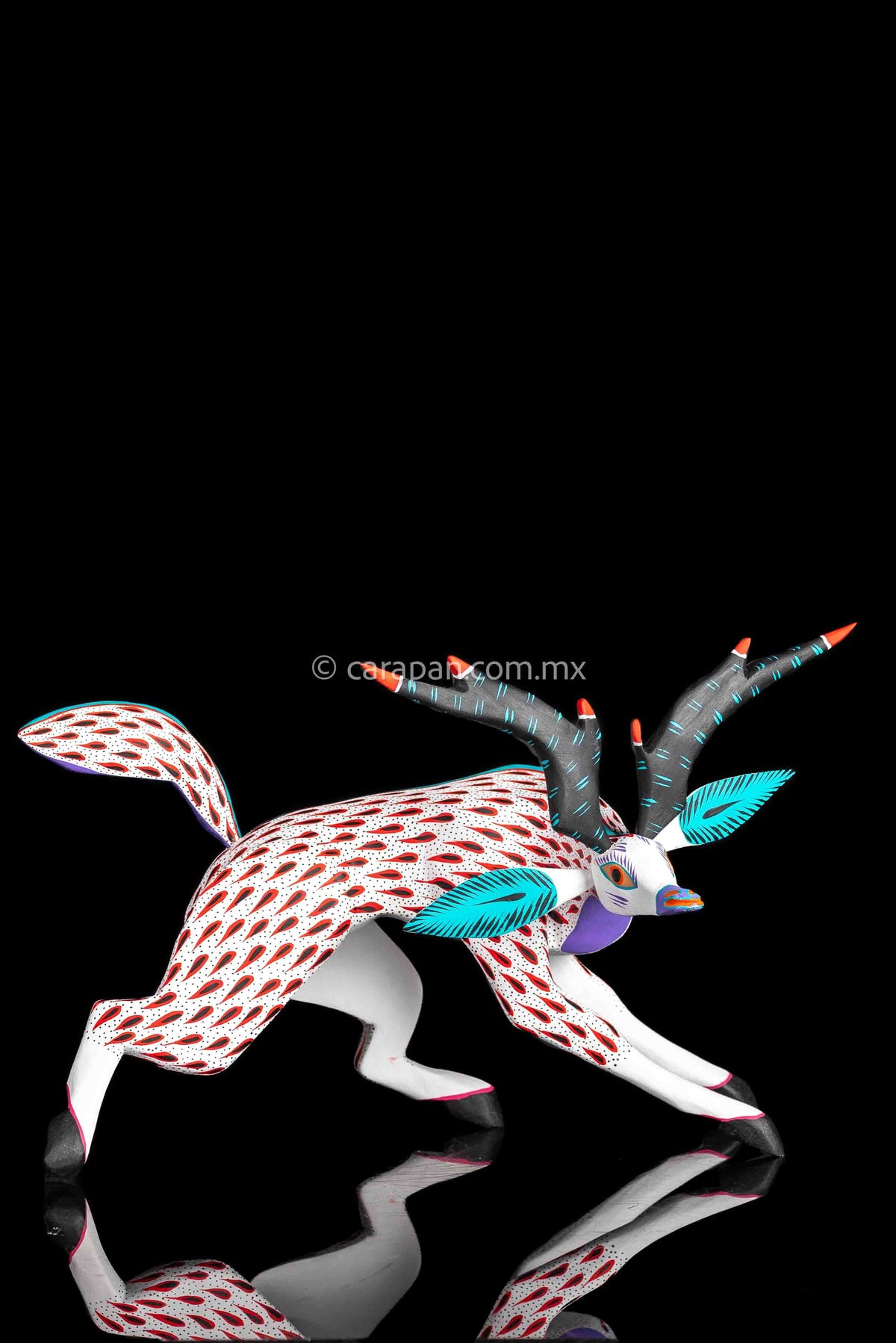 Deer Wooden Sculpture in white decorated with red strokes and small black dots. Ears, horns and tail are detachable