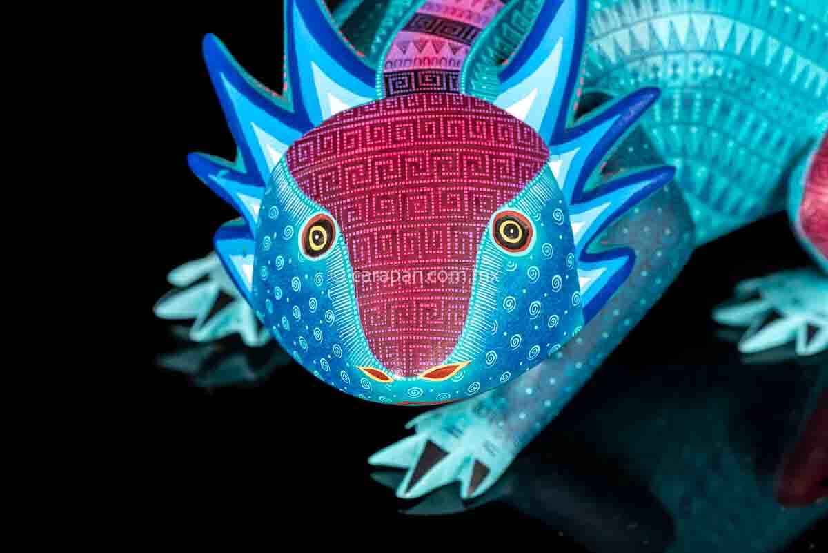 Axolotl Oaxacan wood carving decorated with zapotec symbols in a turquoise & Fucsia palette