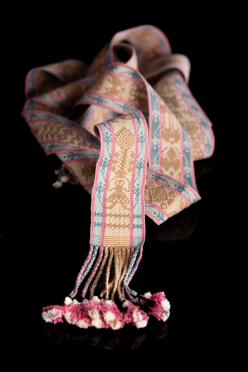 Backstrap Loomed Belt  decorated With Traditional Zapotec Figures in Brown at the center and a stripe with hummingbirds in blue with pink contour on each side One end of the belt is decorated with dolls in pink & the other with boys in blue dyed with natural pigments: Walnut, Cochineal & Indigo