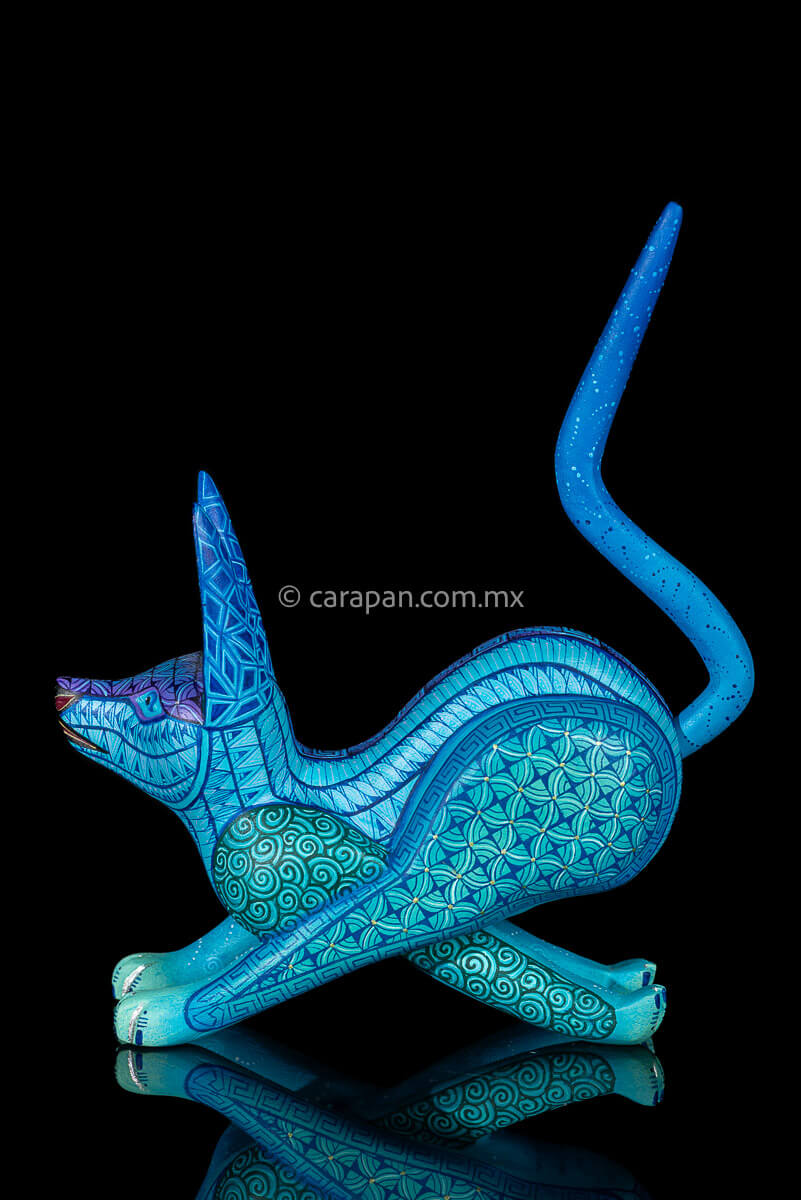 Wooden Sculpture of a Coyote Running decorated with Zapotec indigenous symbols in turquoise and blue tones 