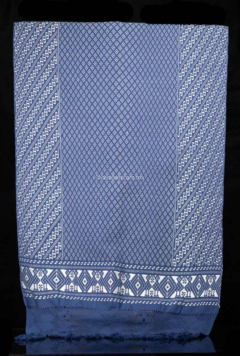 Purepecha Indigenous Textile Backstrap Loomed with mesmerizing patterns in blue and white.Reversible, in one side white dominates over blue. The other side blue dominates over white. The border is decorated with  birds and the blue fringe displays a  hand knotted openwork with flowers.