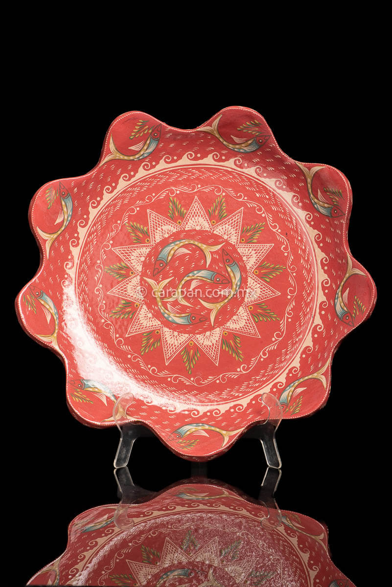 Capula Galzed Dish with flower shape curvy contour  decorated with fishes,  wave patter and a star with 4 swimming fish at the center
