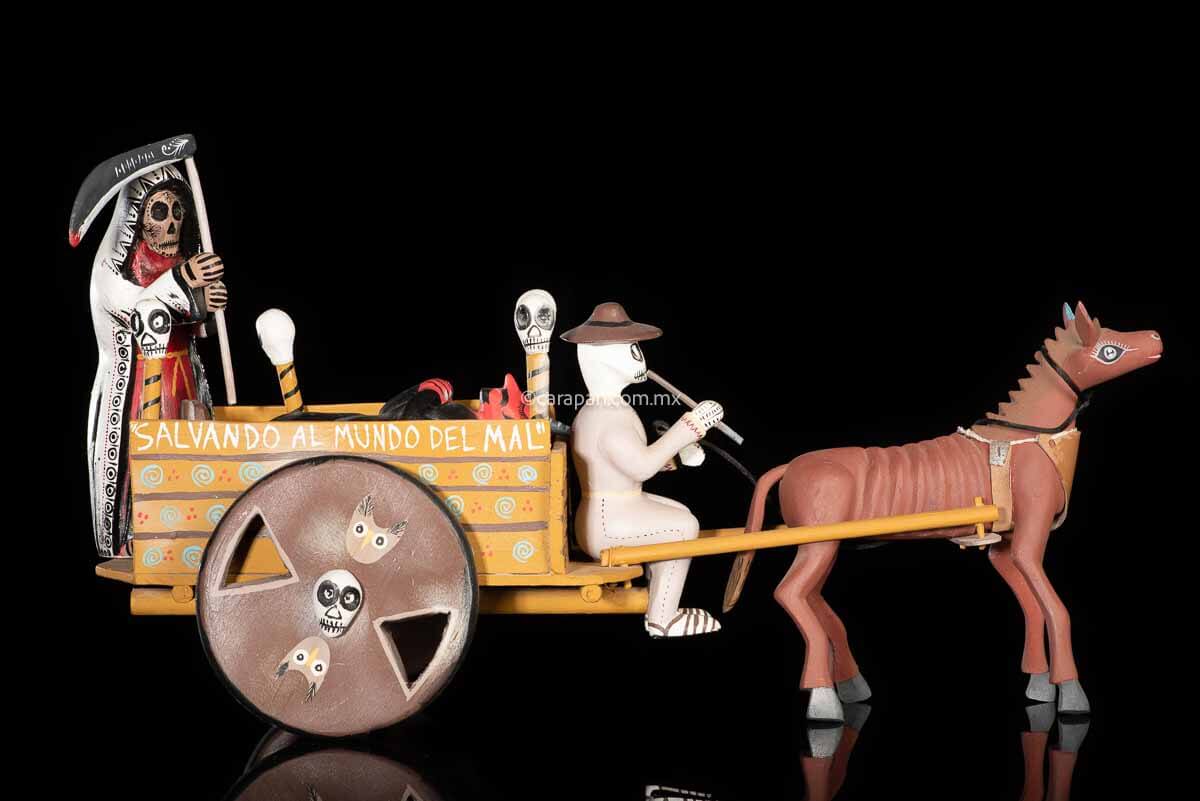 Cart pulled by a brown mule with 1 skeleton as rider & a figure representing the dead on it beside a death devil. The cart displays the legend in spanish that states "saving the world from evil" on one side & "Death's cart driver on the other side"