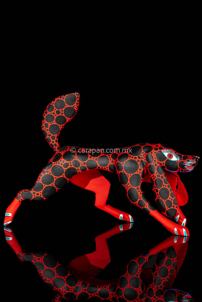 Alebrije Wood Carving Sculpture of walking dog in red with black round patches