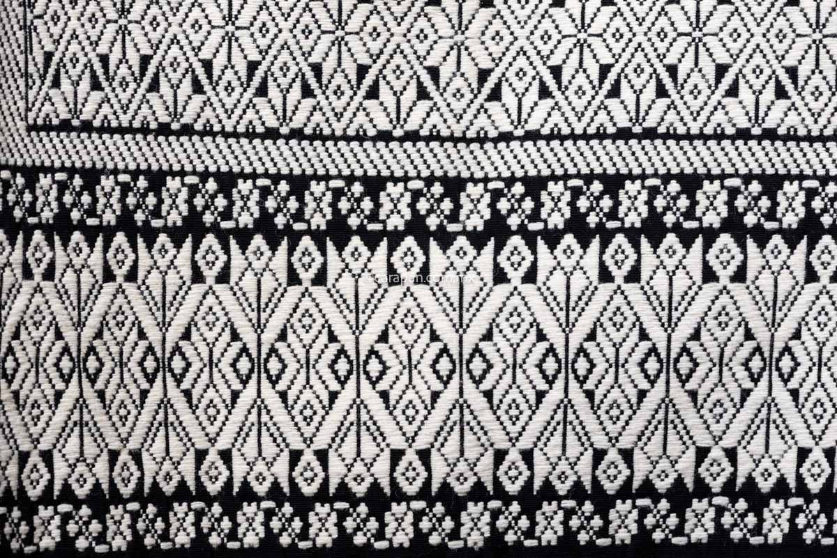 Purepecha Indigenous Textile Backstrap Loomed with mesmerizing patterns in blue and white.Reversible, in one side white dominates over black. The other side black dominates over white.  The fringe displays a  hand knotted openwork with hearts. 