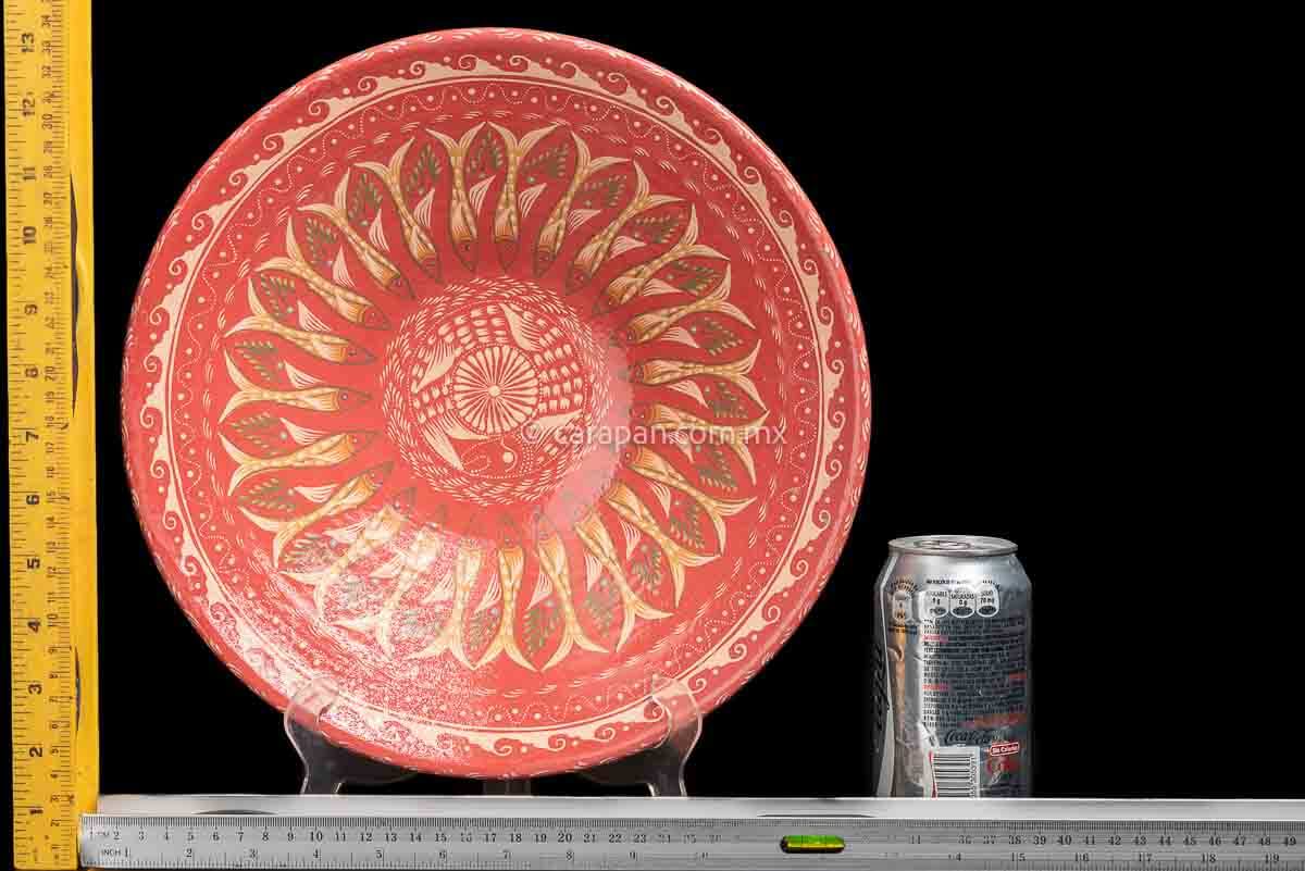 Glazed Bowl with wave pattern contour. An ensemble of many fish surround the center creating a captivating design. The center is decorated with a beige star and a fish around it  rulers