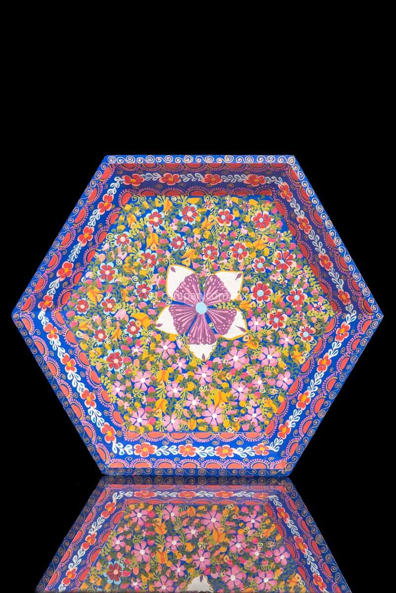 Hexagonal Wooden Tray decorated with red and pink flowers and green leafs over a blue background