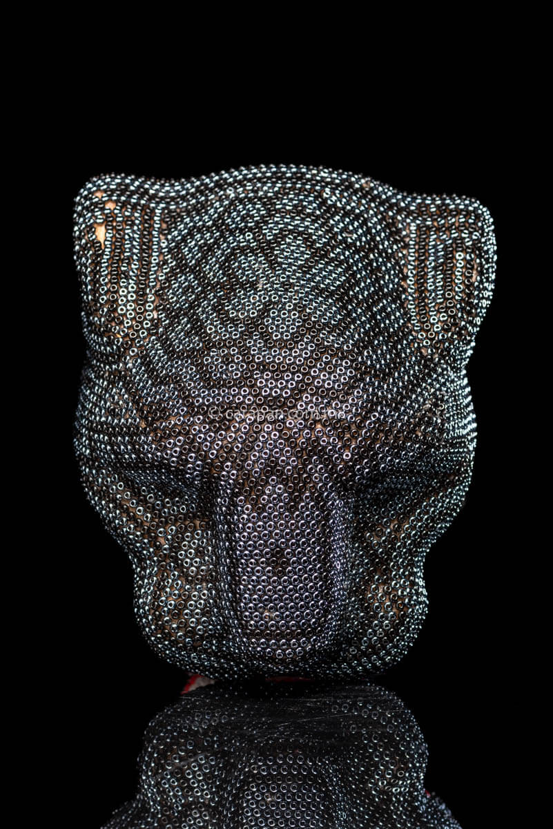 Huichol Jaguar Head Wood Carving covered with Beads in black and silver. The mouth contour is red & The fangs are white. 
